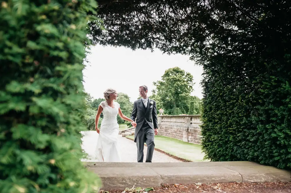 Wedding Photo RM - bride and groom through hedge